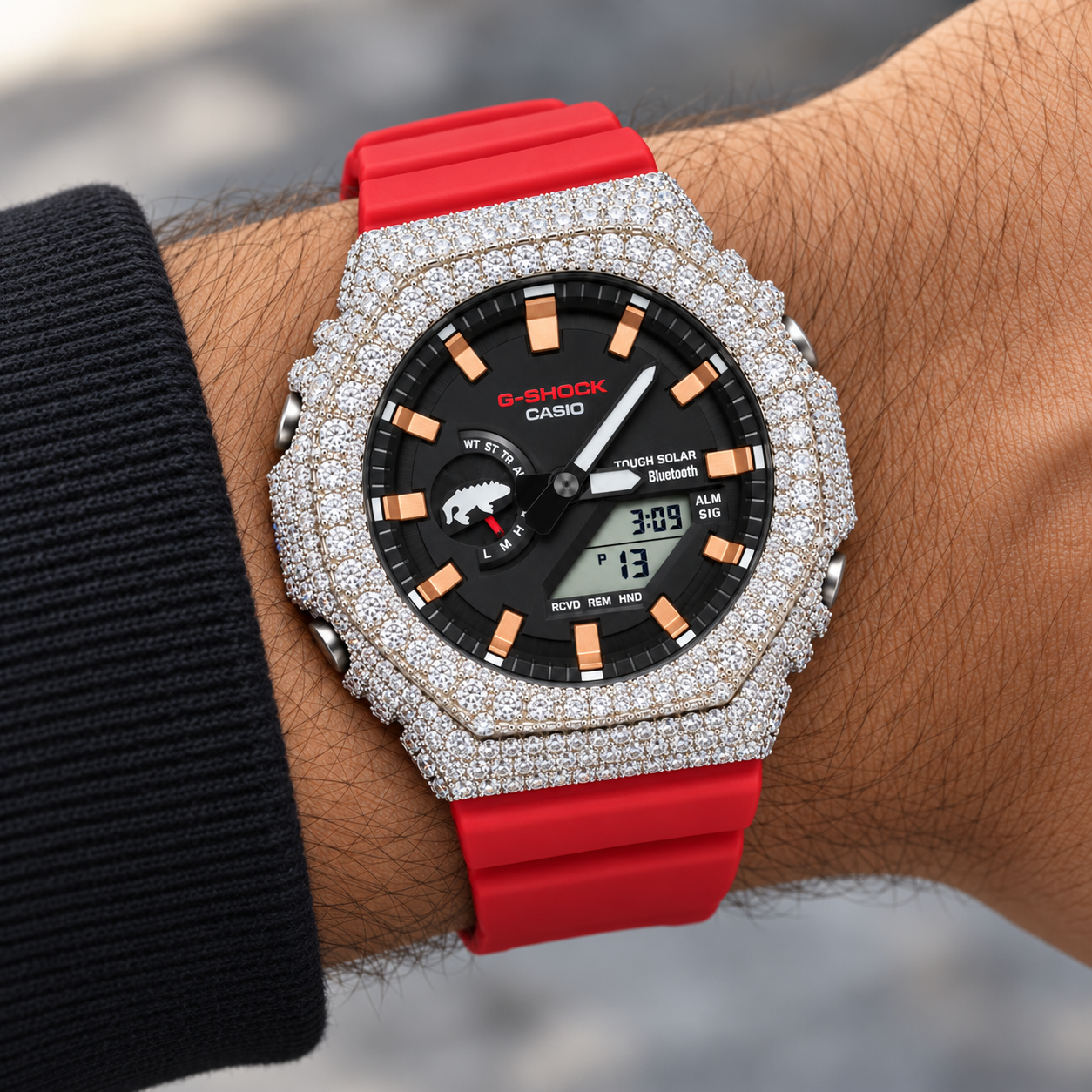 Iced out red band G-Shock watch on wrist