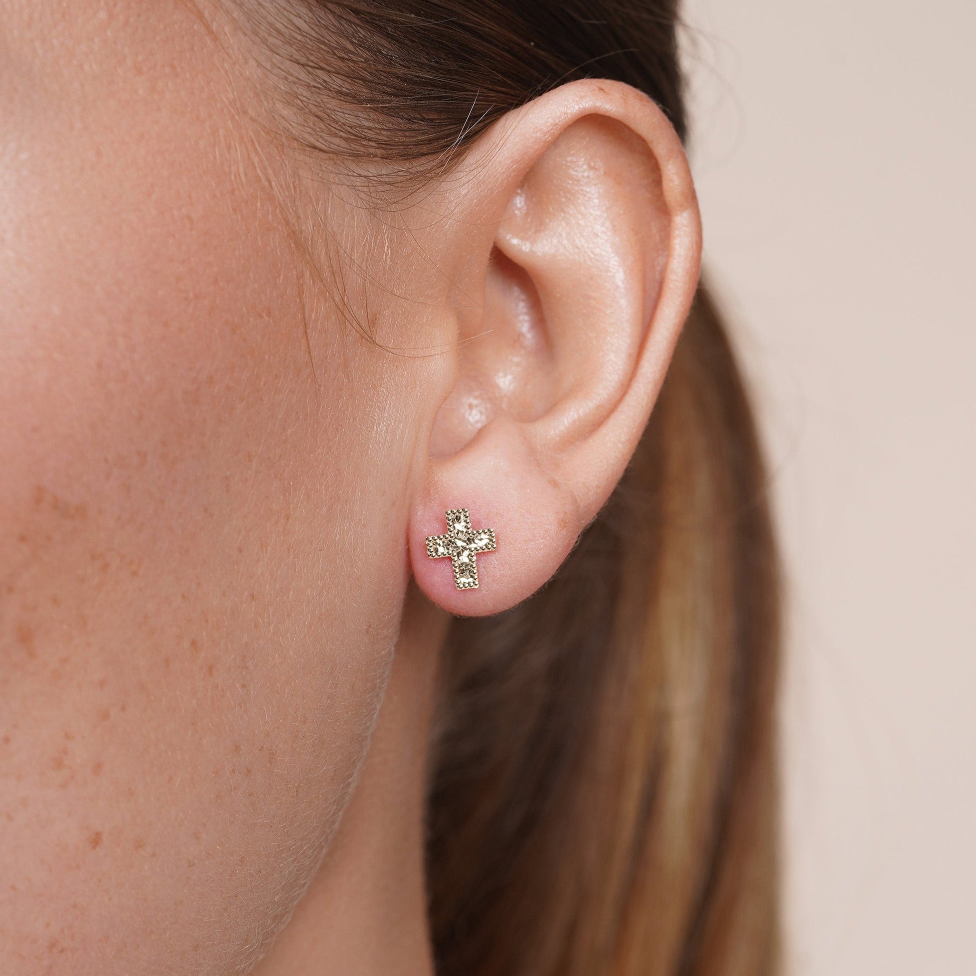 Diamond-cut confetti cross stud earrings in 14 karat gold, detail view