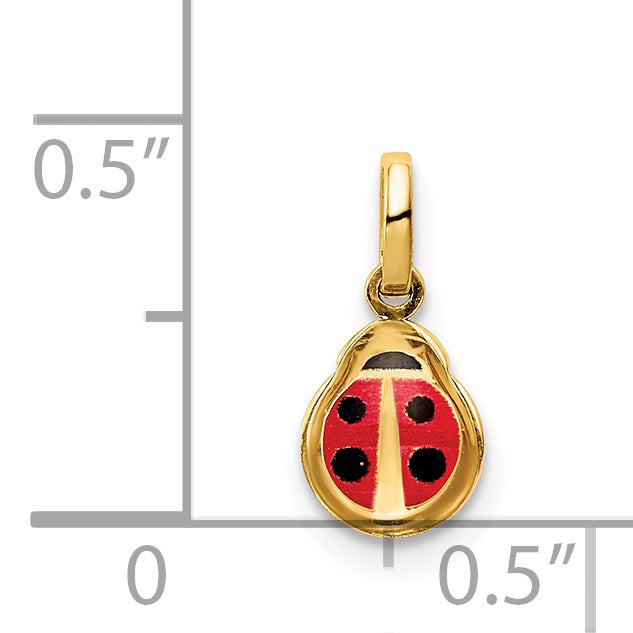 Small 14K gold ladybug charm next to a half inch scale