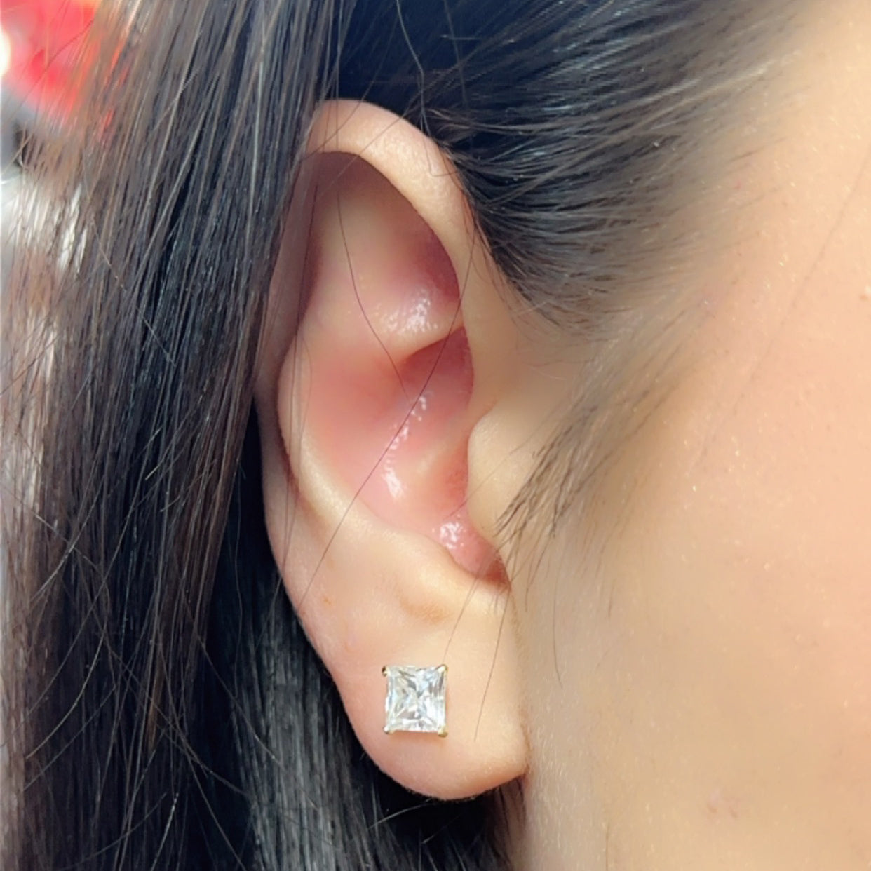 Square moissanite stud earrings in 14 karat yellow gold, side view
