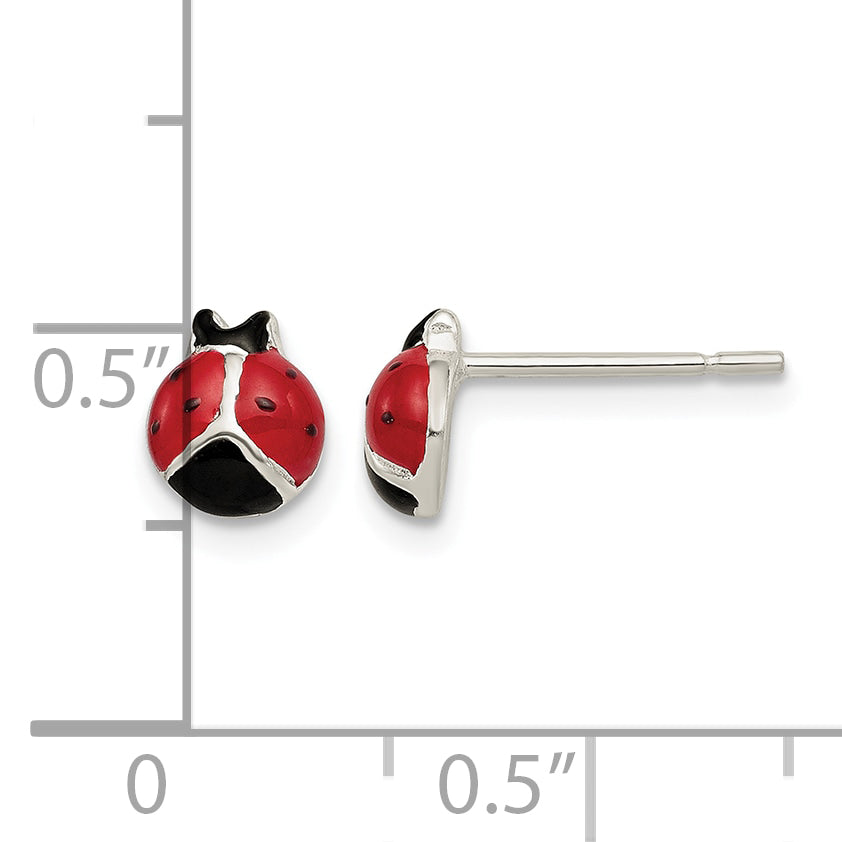 Sterling silver ladybug stud earrings next to a half inch scale