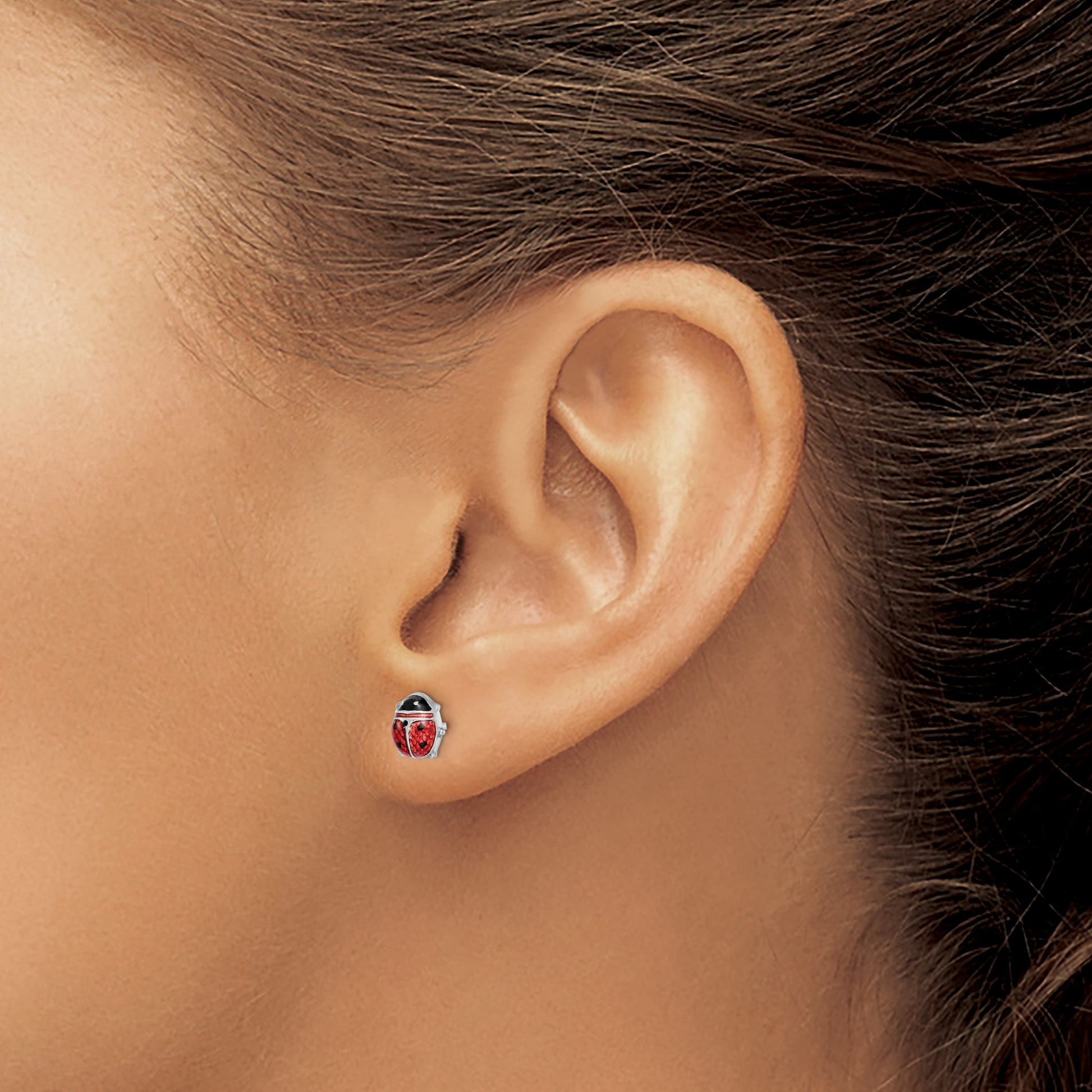 Sterling silver enamel ladybug stud earring worn on the ear