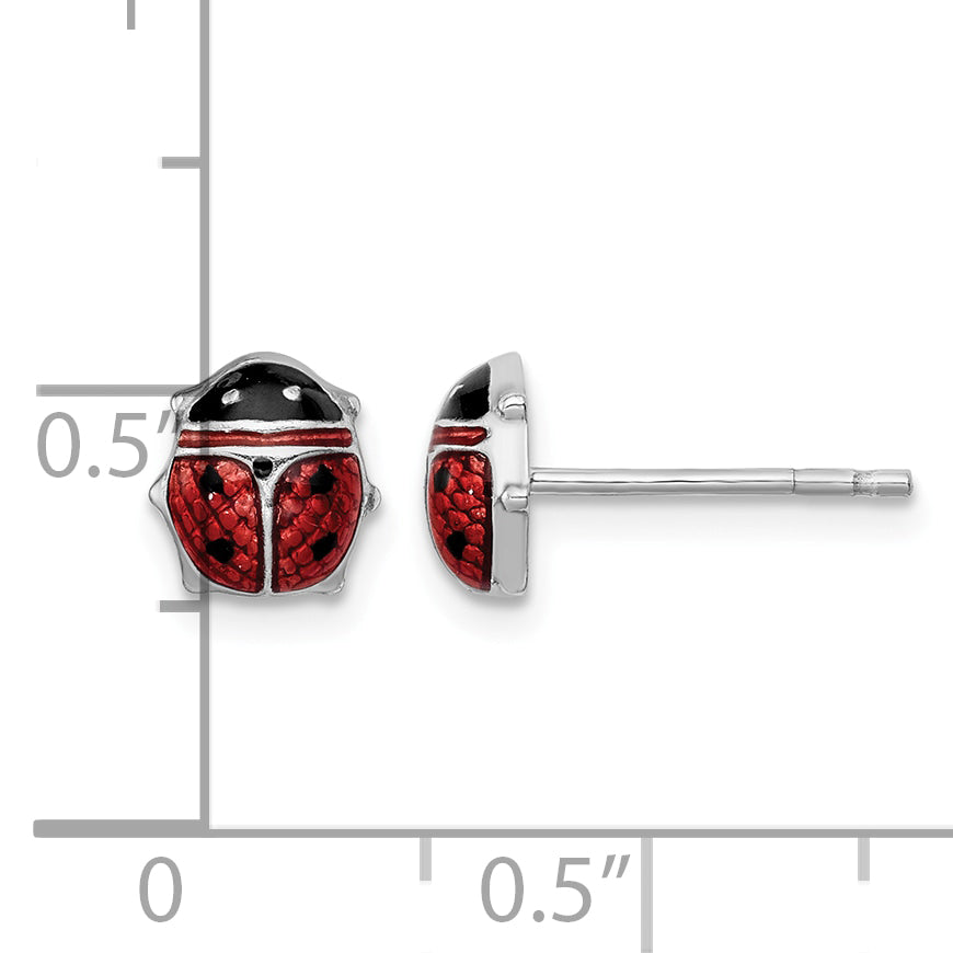 Sterling silver ladybug stud earrings next to a half inch scale