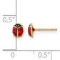14K gold ladybug stud earrings next to a half inch scale
