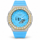 Iced out G-Shock watch with sky blue band and gold-accent bezel - front