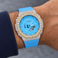 Iced out sky blue G-Shock watch on wrist